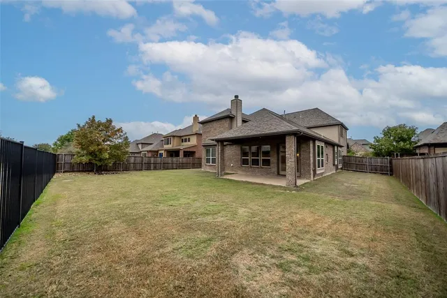 a front view of a house with a garden and patio