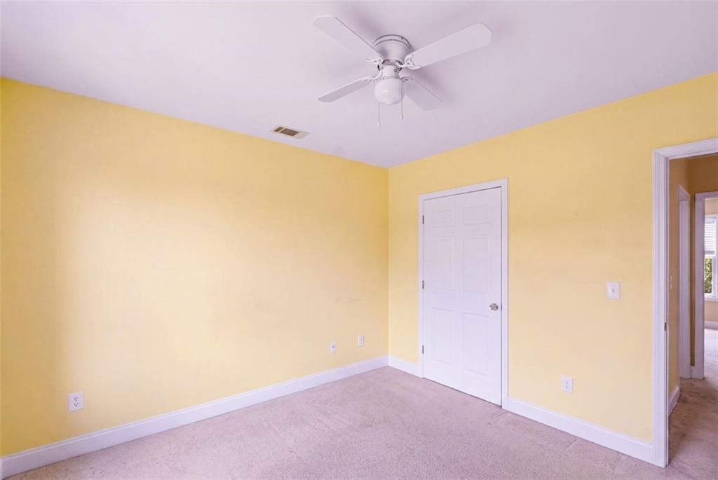 3420 Bulloch Lake Road Loganville, GA 30052 - Photo 45 of 57 an empty room with a ceiling fan and a window
