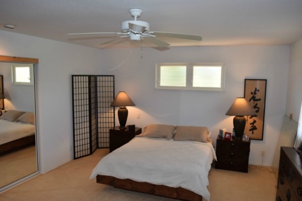 4790 Pelehu Road Kapaa, HI 96746 - Photo 4 of 17 a bedroom with a bed and a chandelier