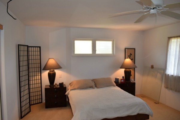 4790 Pelehu Road Kapaa, HI 96746 - Photo 8 of 17 a bedroom with a bed and a lamp