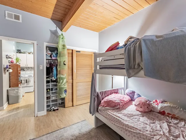 a bedroom with a bed and a walk in closet