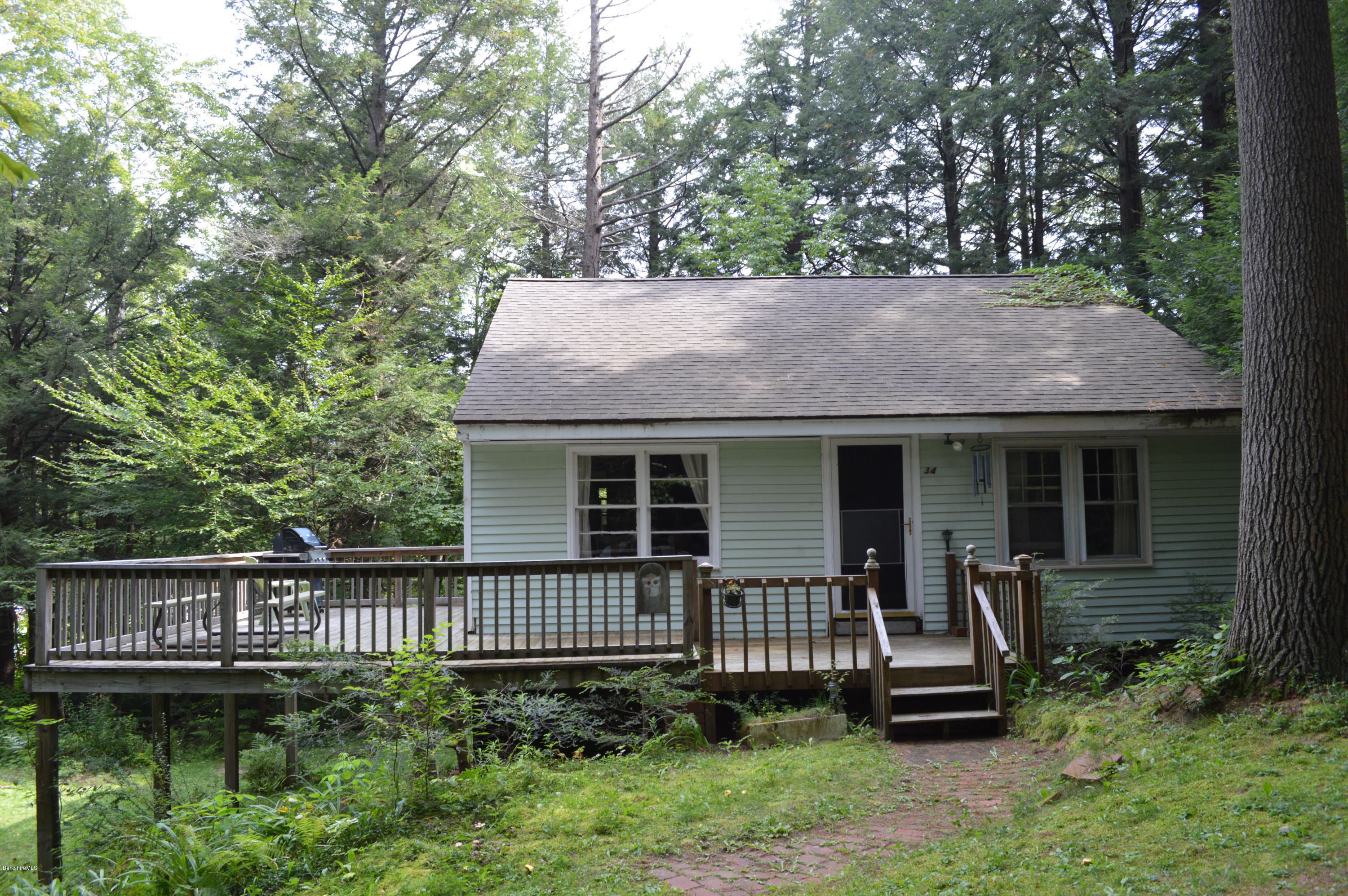 34 Highland Road Becket, MA 01223 - Photo 1 of 35 a view of a house with a yard and furniture
