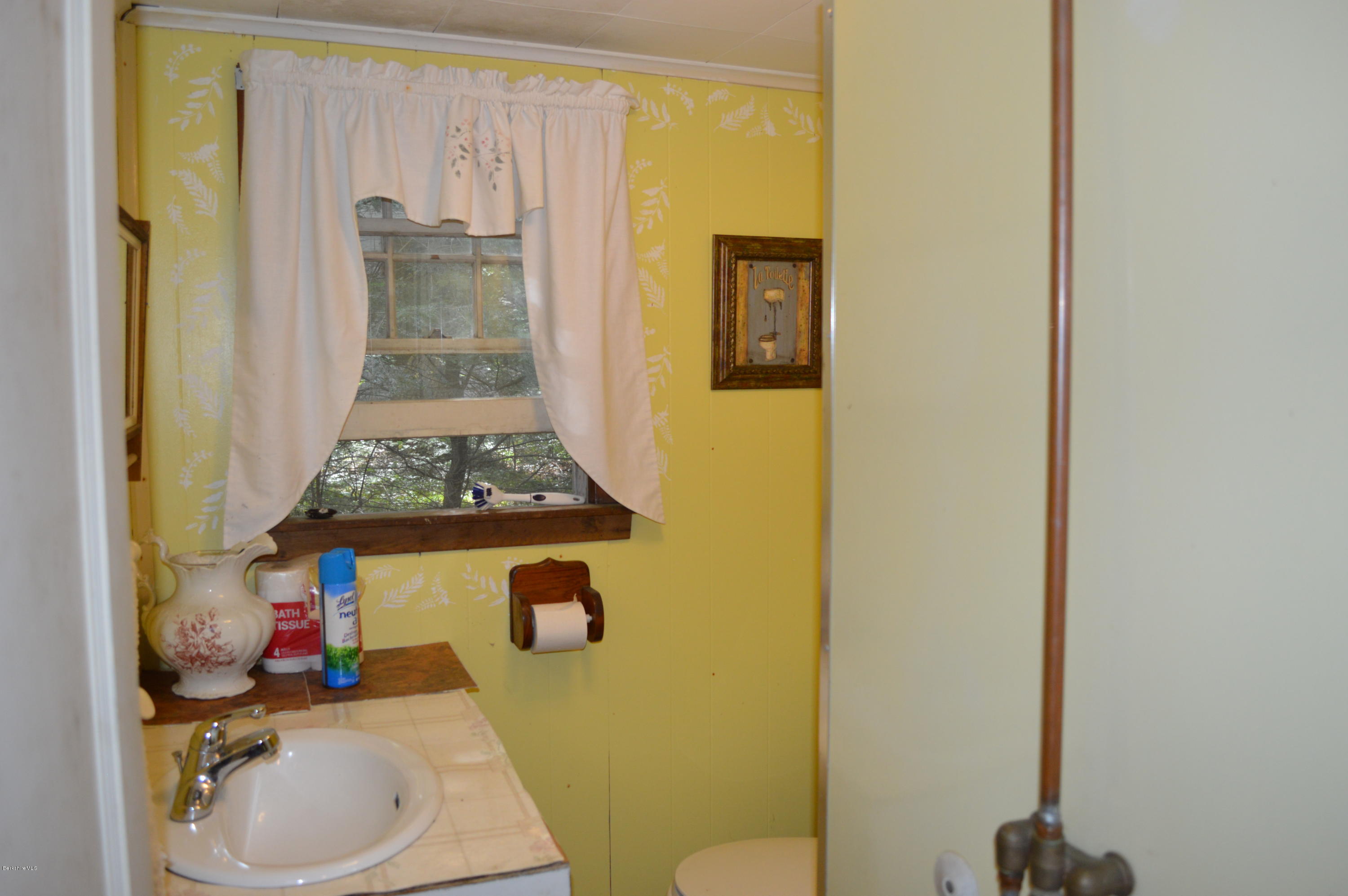 34 Highland Road Becket, MA 01223 - Photo 14 of 35 a bathroom with a sink toilet and shower