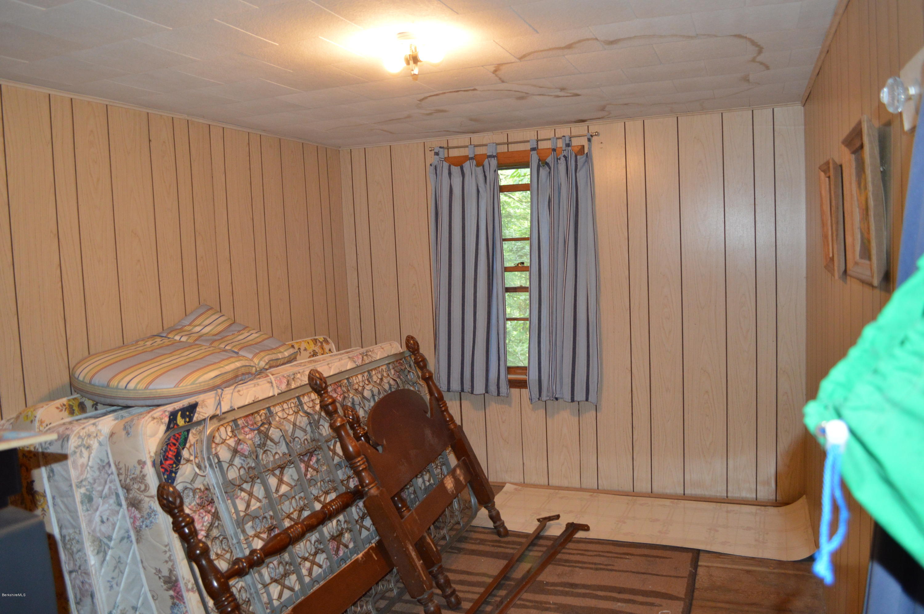 34 Highland Road Becket, MA 01223 - Photo 16 of 35 a bed sitting in a spacious bedroom next to a window