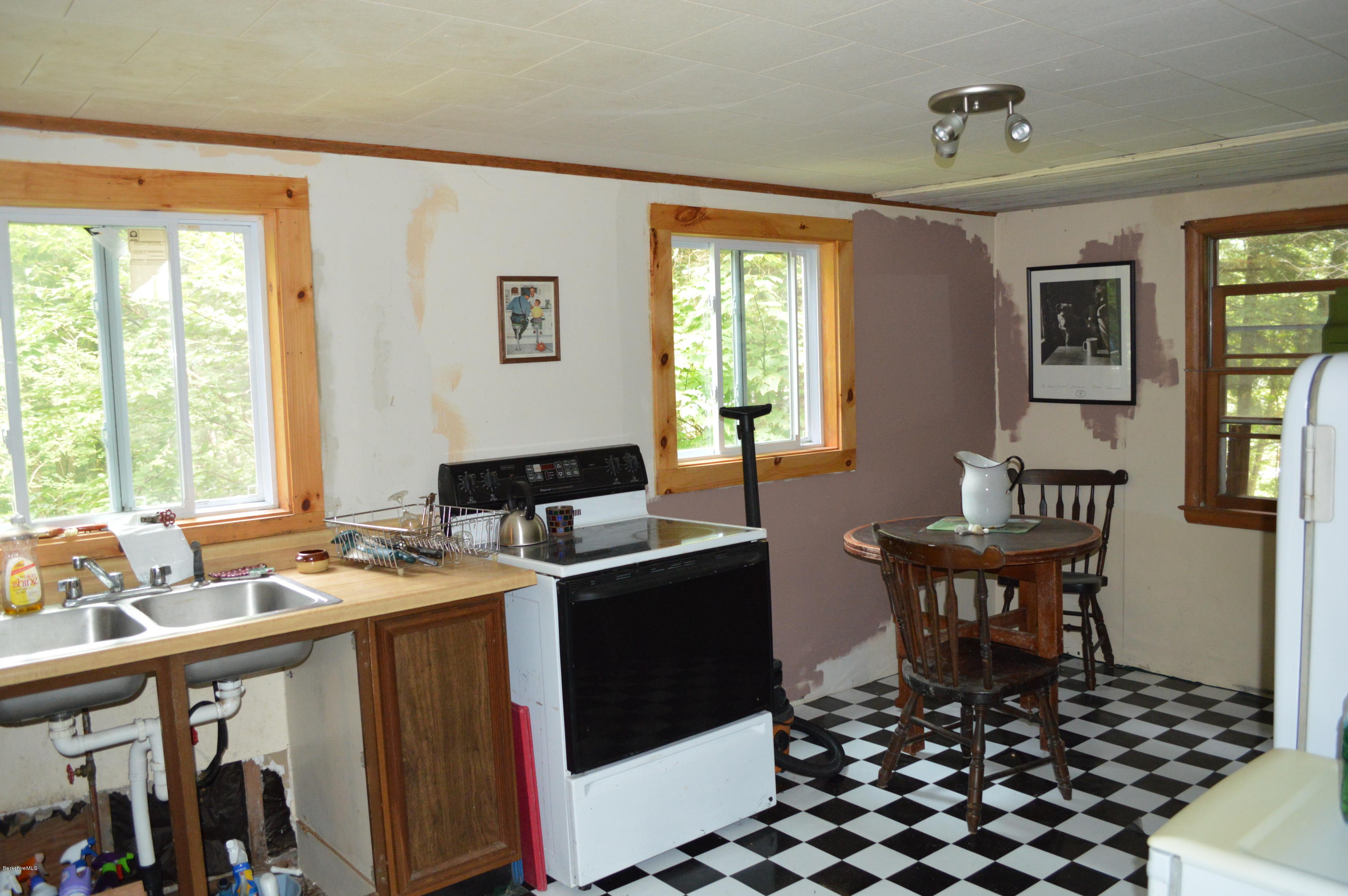 34 Highland Road Becket, MA 01223 - Photo 17 of 35 a room with granite countertop a sink a counter top space and living room