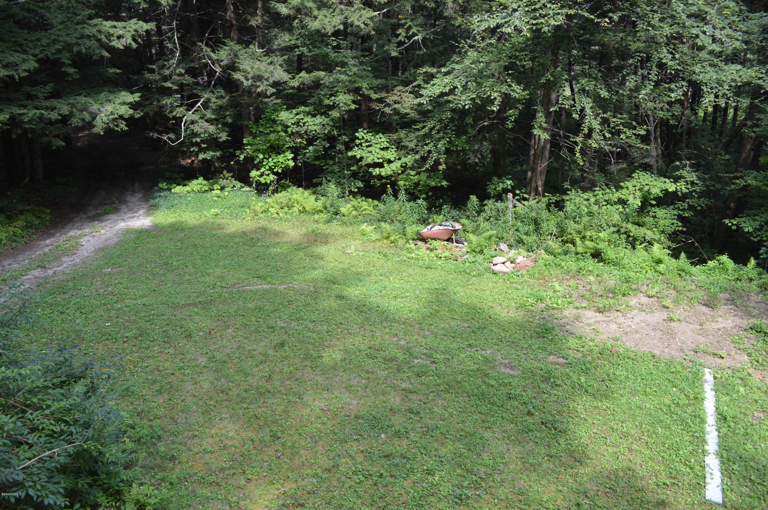 34 Highland Road Becket, MA 01223 - Photo 32 of 35 a backyard of a house with lots of green space