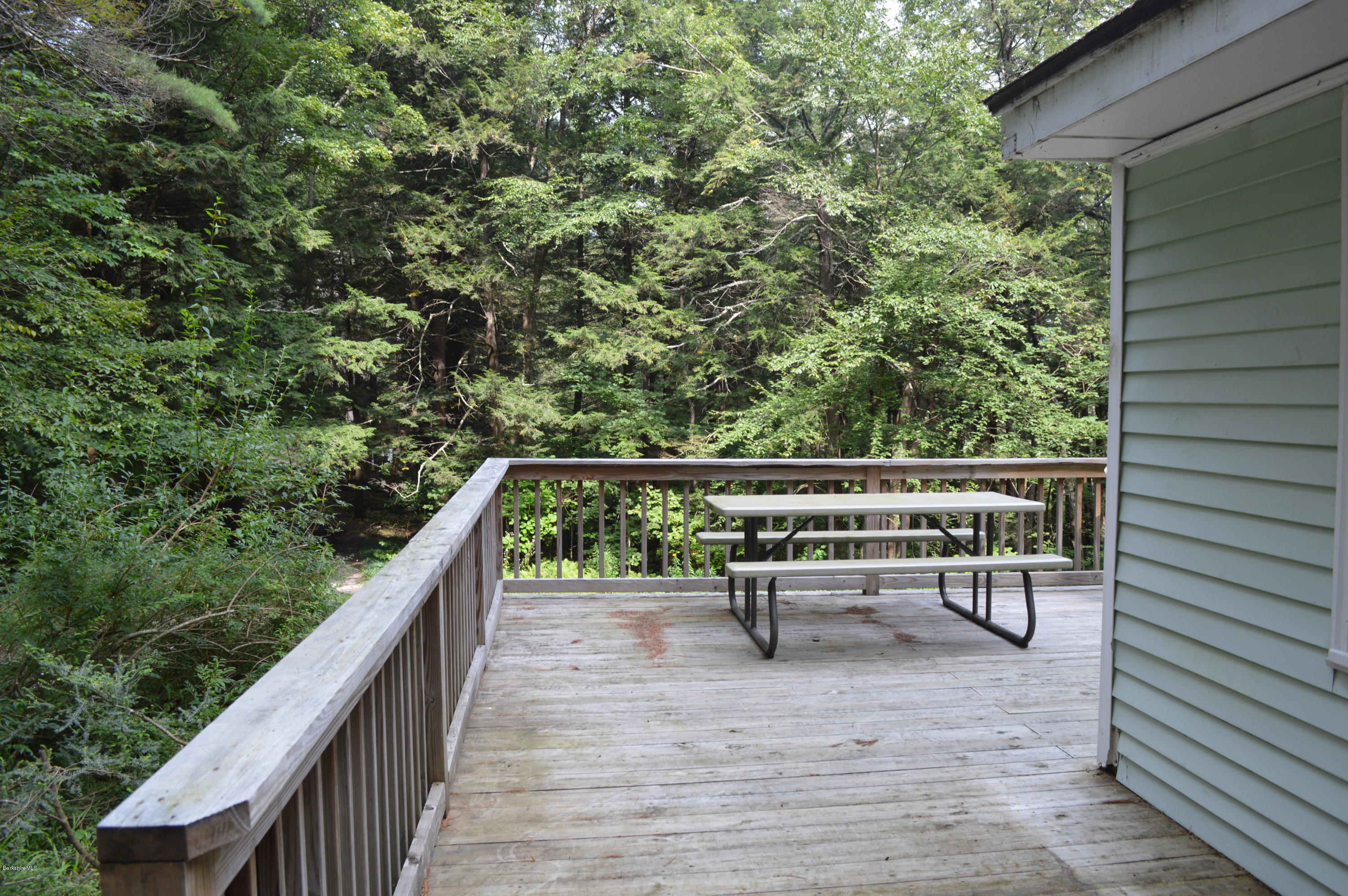34 Highland Road Becket, MA 01223 - Photo 10 of 35 a balcony with wooden floor and bench