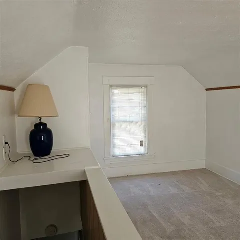 a room with a bed and a lamp