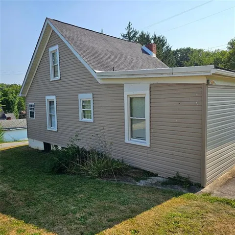 a aerial view of a house next to a yard