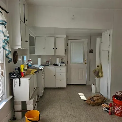 a room with a sink storage and utility