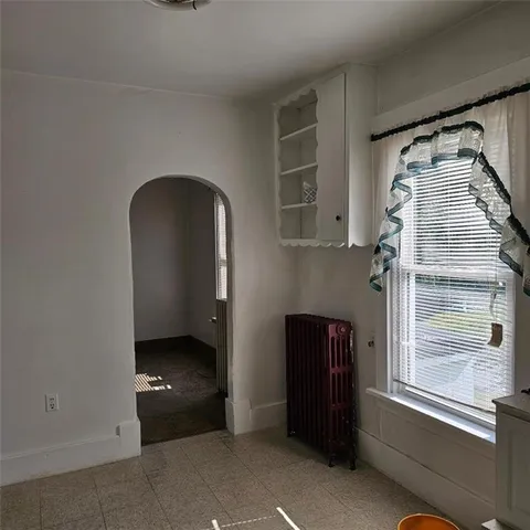 a view of a utility room with closet and windows