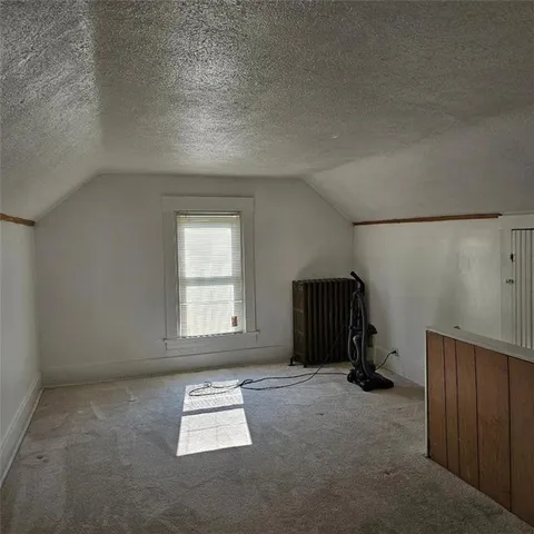 an empty room with a window and a ceiling fan