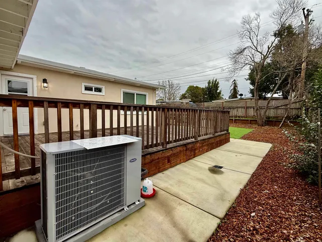 a view of a roof deck with wooden fence