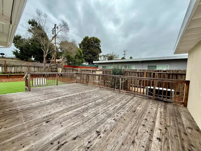 a view of a balcony with wooden floor