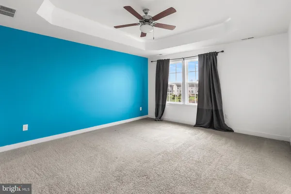 a view of an empty room with a ceiling fan
