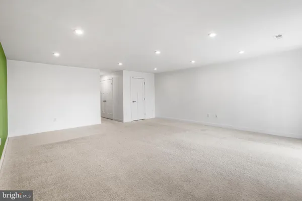 a living room with furniture and large windows