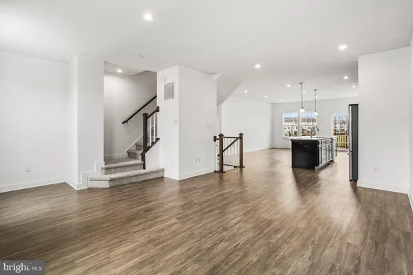 a kitchen with stainless steel appliances a refrigerator and a stove top oven
