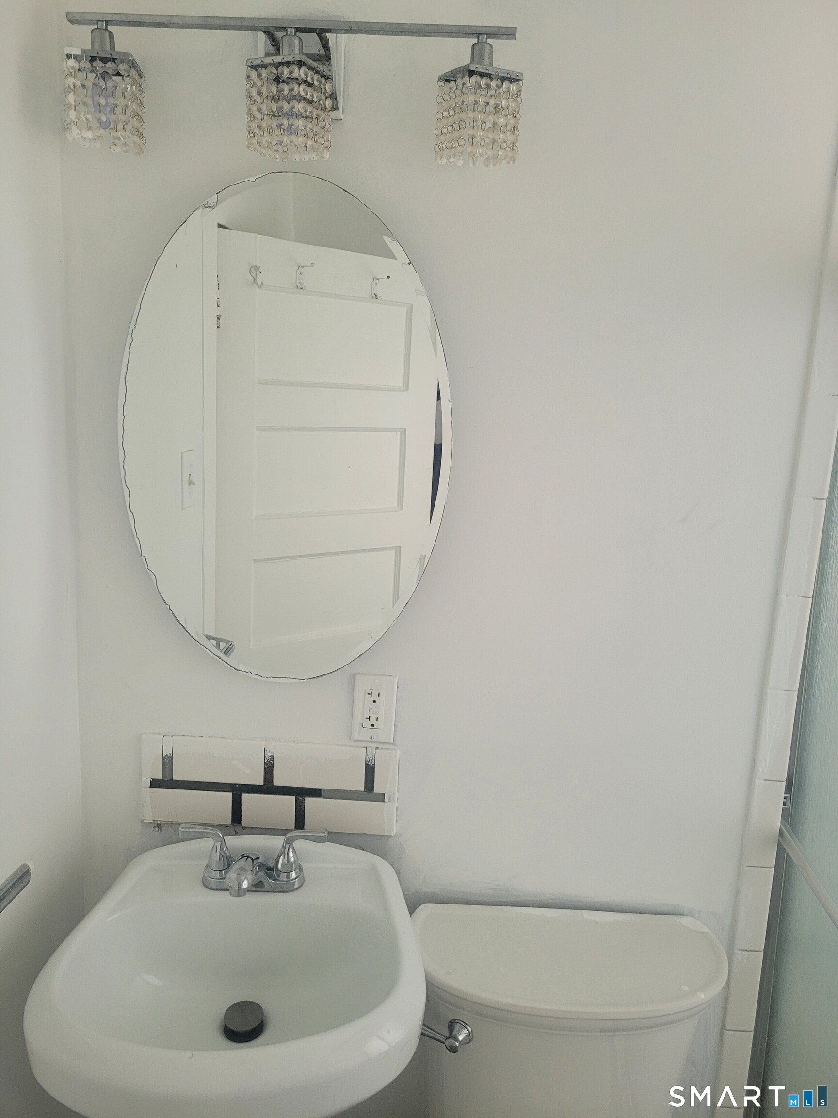606 Wilmot Avenue, Unit 4 Bridgeport, CT 06607 - Photo 9 of 16 a bathroom with a sink a mirror and vanity