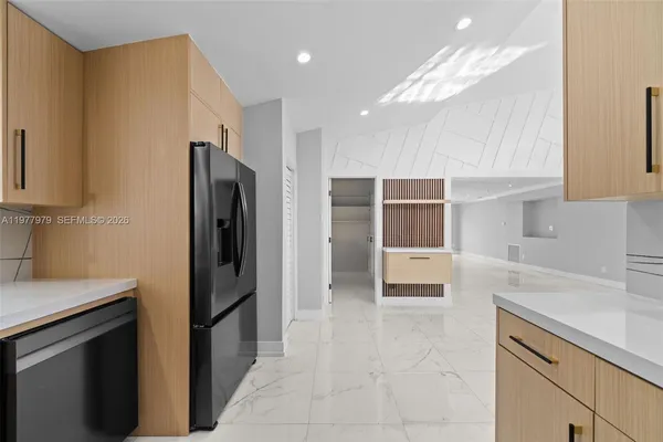 a kitchen with stainless steel appliances a refrigerator and a sink