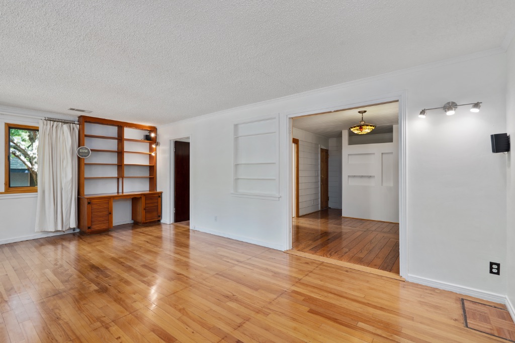 1212 Bentwood Road Austin, TX 78722 - Photo 6 of 32 wooden floor in an empty room with a window