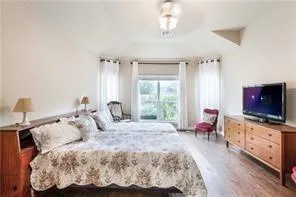 a bedroom with a bed and a flat screen tv