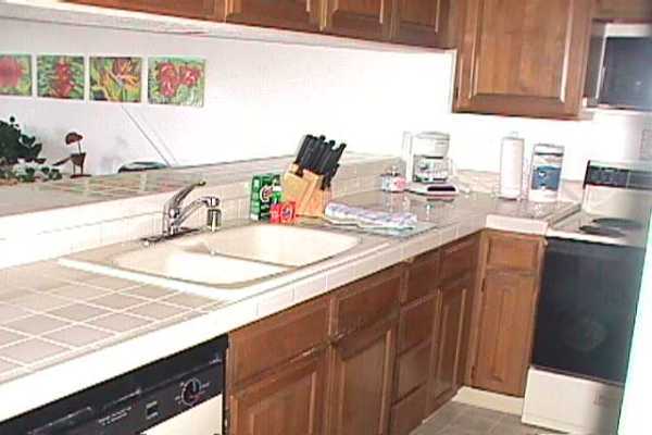 1568 Pe'e Road, Unit 212 Koloa, HI 96756 - Photo 22 of 25 a kitchen with a sink and a cabinets