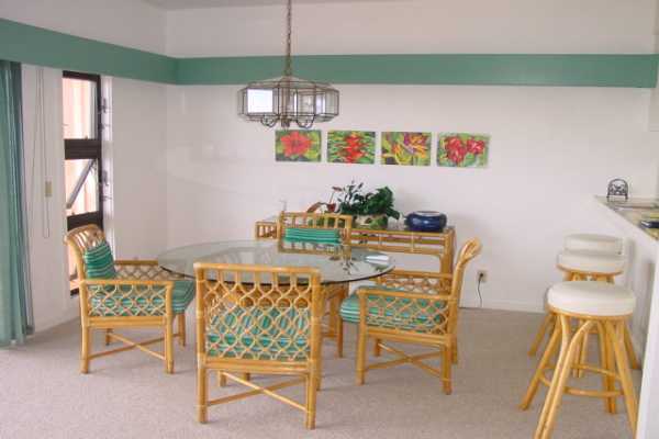 1568 Pe'e Road, Unit 212 Koloa, HI 96756 - Photo 3 of 25 a view of a dining room with furniture and chandelier