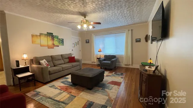 a living room with furniture and a mirror