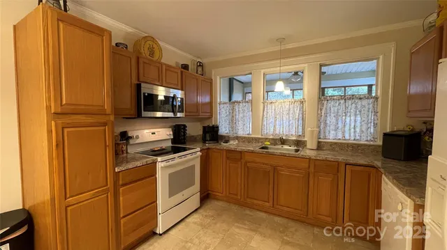 a kitchen with a sink and a granite counter top