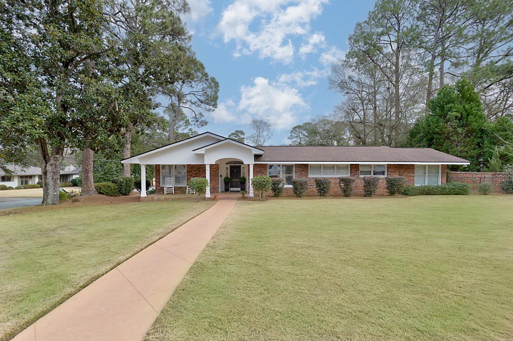 a front view of a house with a garden