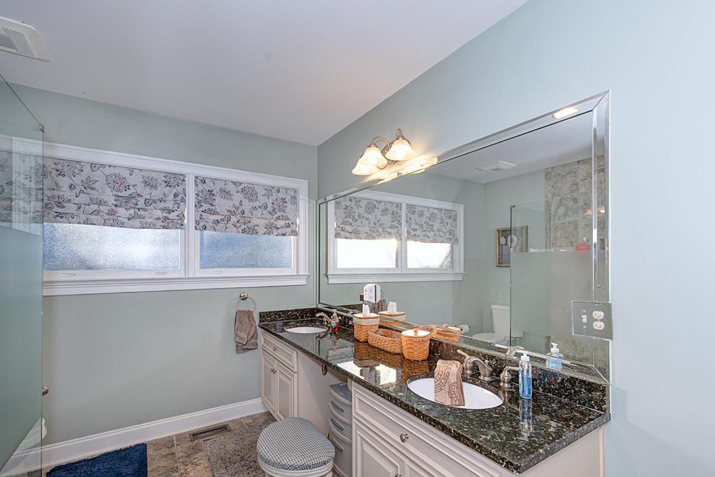 2008 Stark Avenue Columbus, GA 31906 - Photo 26 of 32 a bathroom with a granite countertop sink a toilet and a mirror
