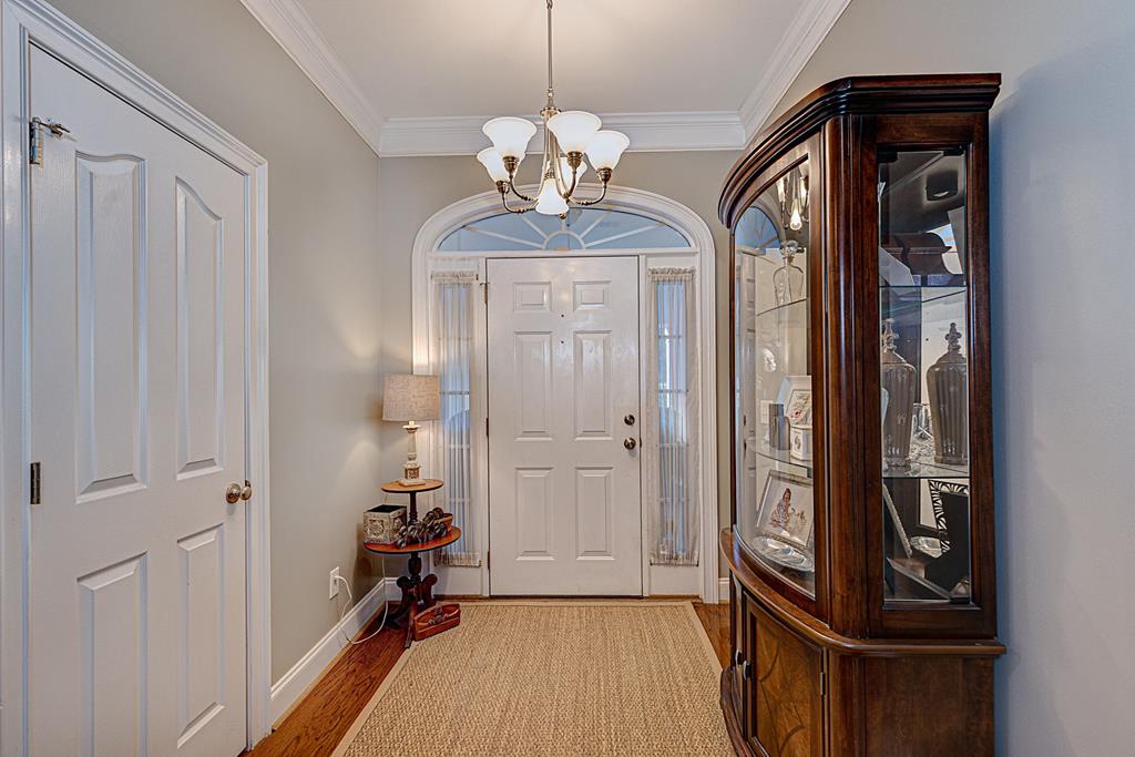 2008 Stark Avenue Columbus, GA 31906 - Photo 8 of 32 a view of a hallway with wooden floor and a chandelier