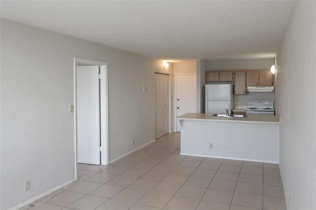a large white kitchen with a sink