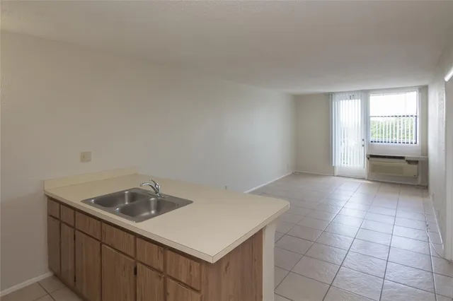 a kitchen with a sink cabinets and window