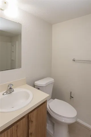 a white toilet sitting next to a bathroom sink