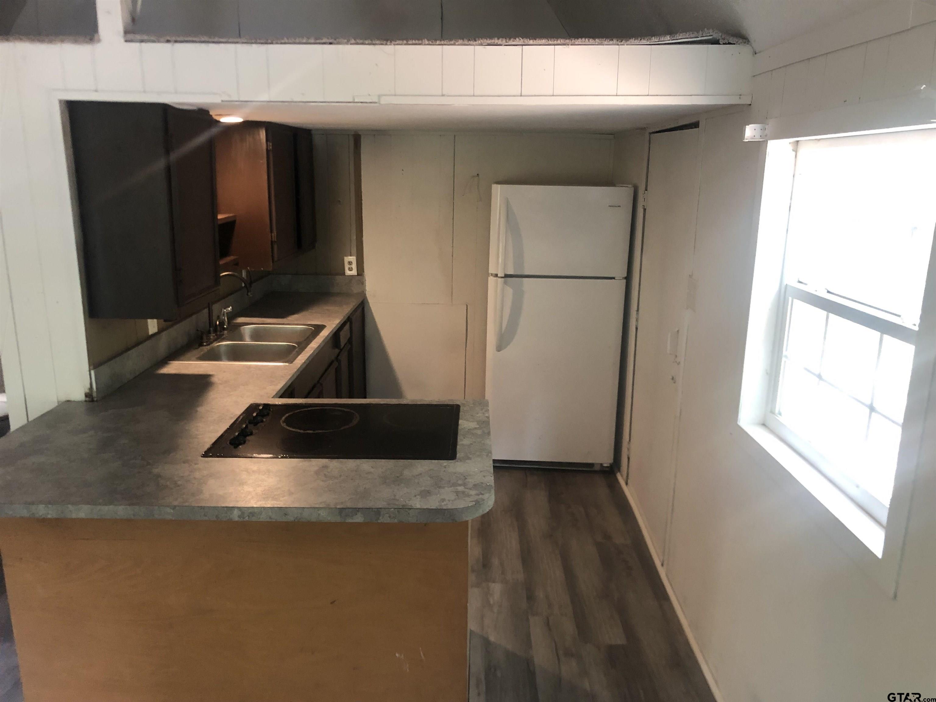347 Sabinal Street Bullard, TX 75757 - Photo 3 of 6 a kitchen with a sink and a refrigerator