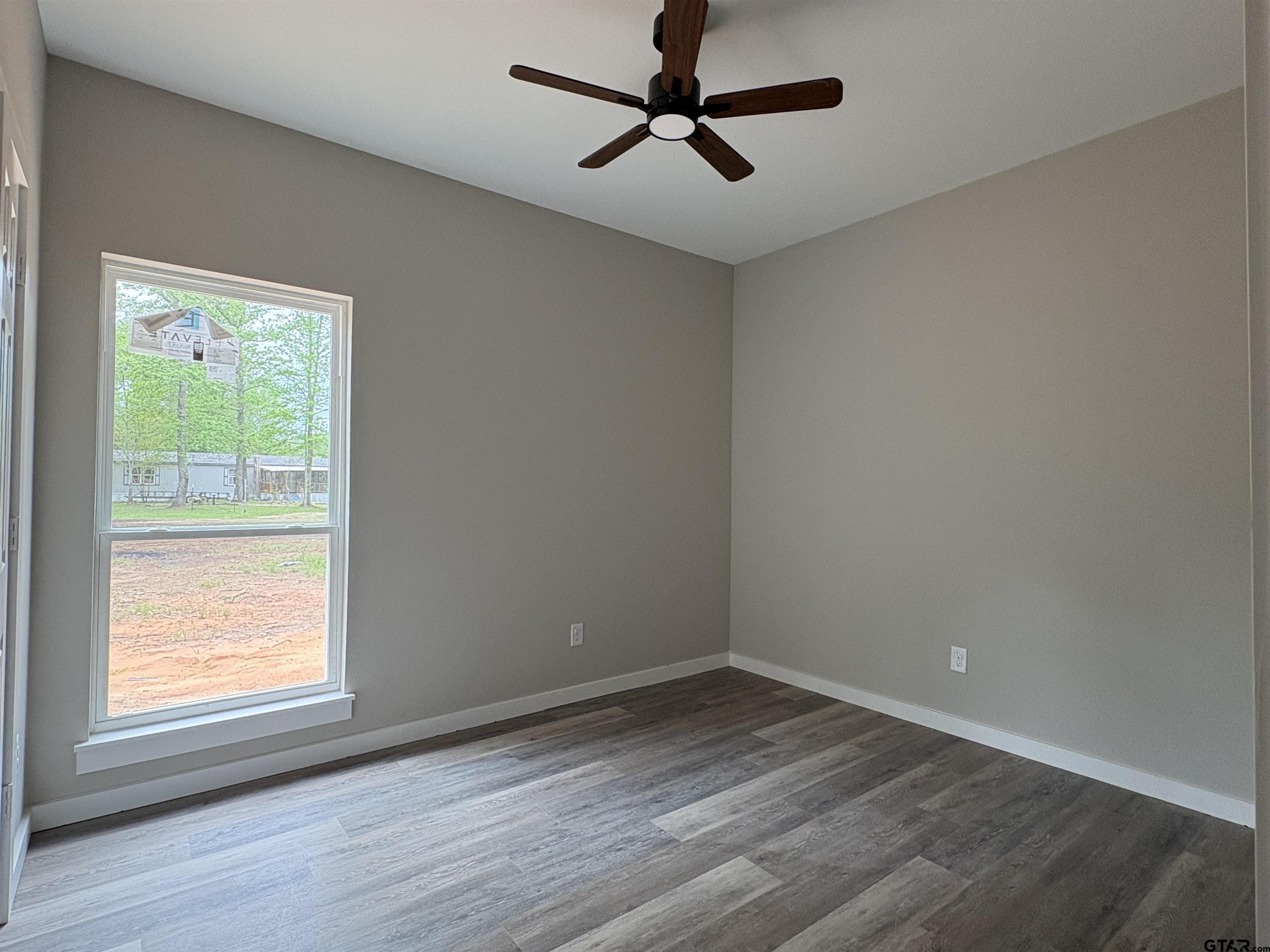 347 Sabinal Street Bullard, TX 75757 - Photo 4 of 6 an empty room with a window and a ceiling fan