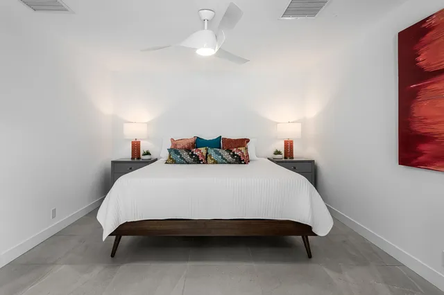 a bedroom with a bed and a table