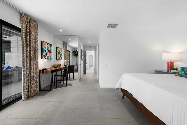 a spacious bedroom with a bed and a cabinets