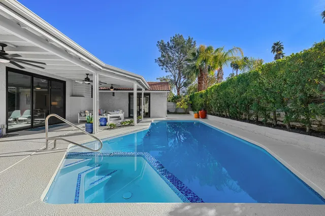 a view of a swimming pool with an outdoor seating