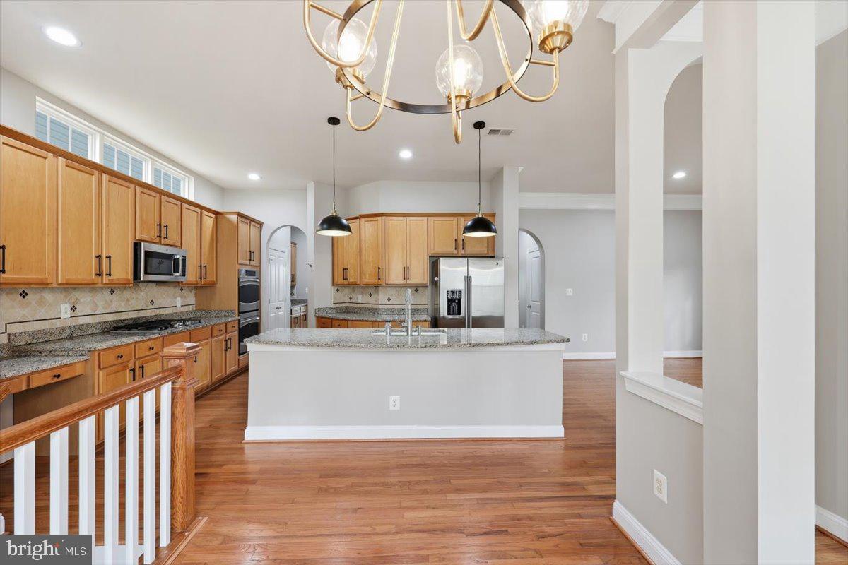 23706 Grapevine Ridge Terrace Clarksburg, MD 20871 - Photo 13 of 39 a large kitchen with stainless steel appliances a large counter top
