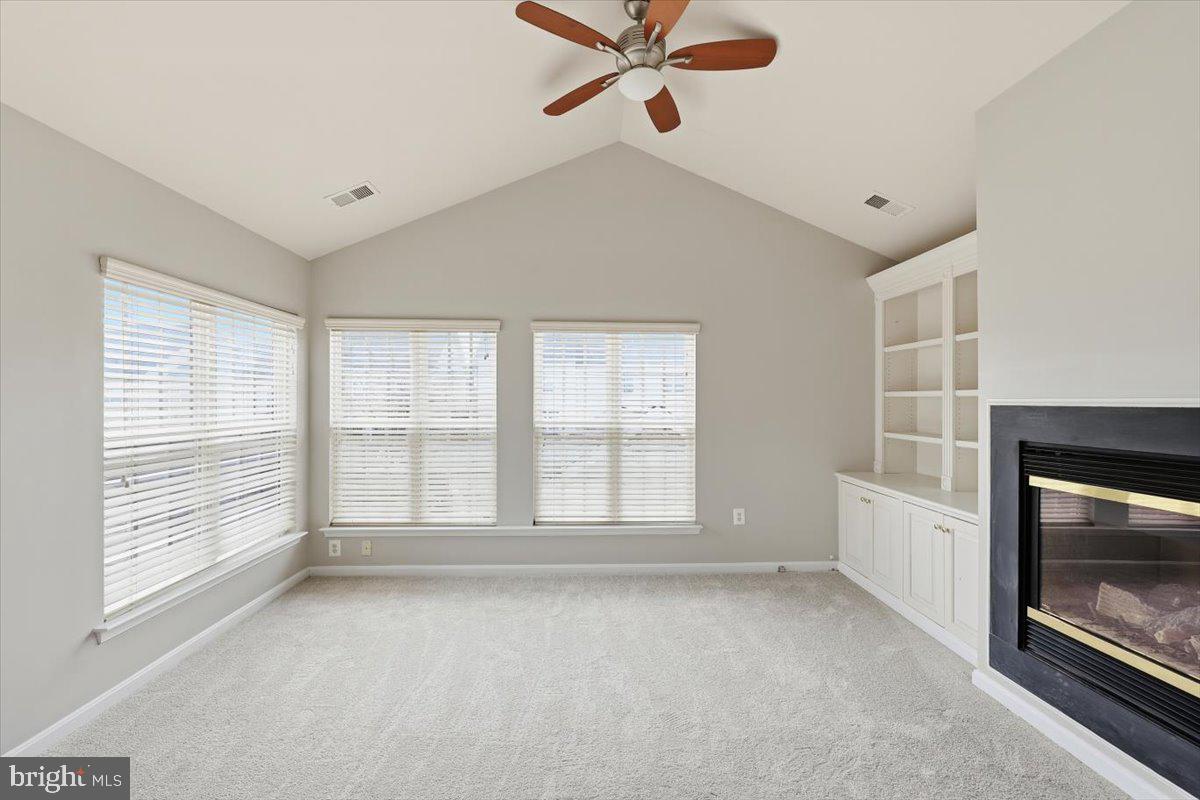 23706 Grapevine Ridge Terrace Clarksburg, MD 20871 - Photo 19 of 39 a view of an empty room with a fireplace and a window