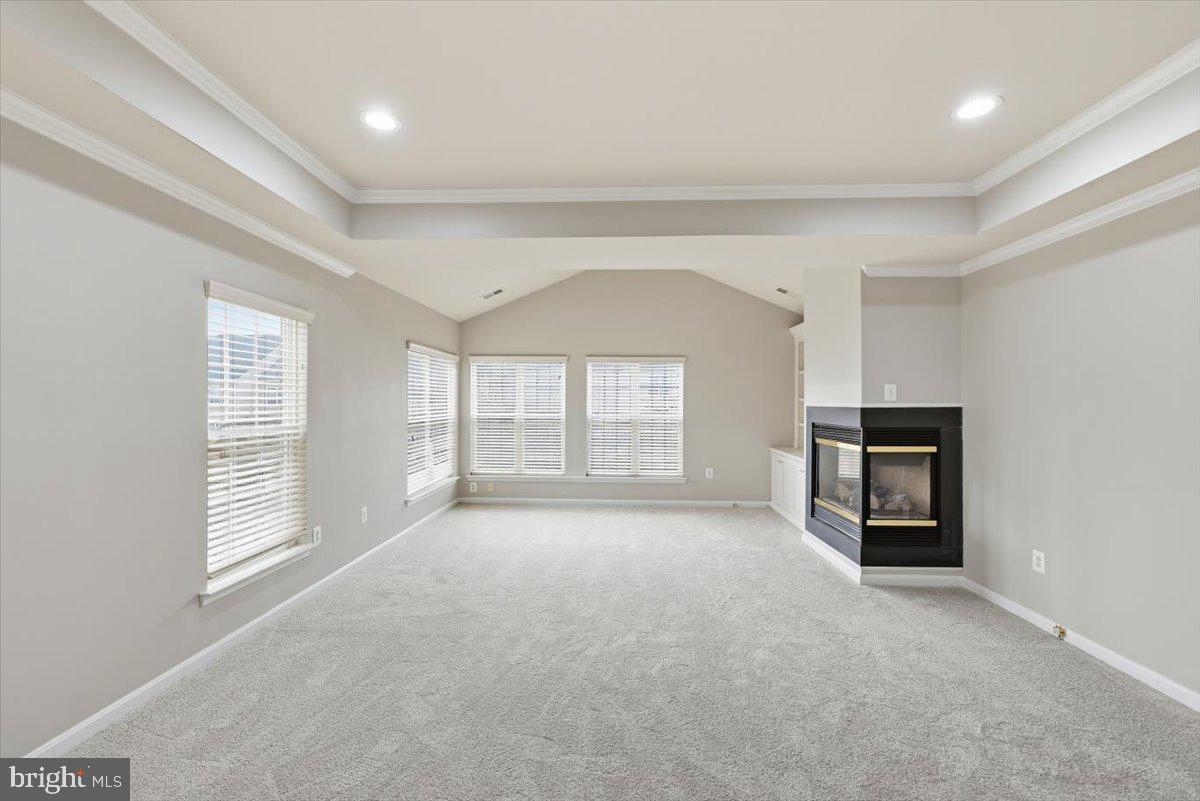 23706 Grapevine Ridge Terrace Clarksburg, MD 20871 - Photo 20 of 39 a view of an empty room with a window and fireplace