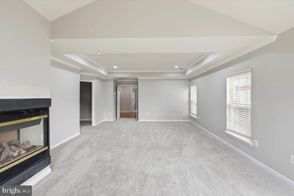 23706 Grapevine Ridge Terrace Clarksburg, MD 20871 - Photo 21 of 39 a view of an empty room with a fireplace and a window