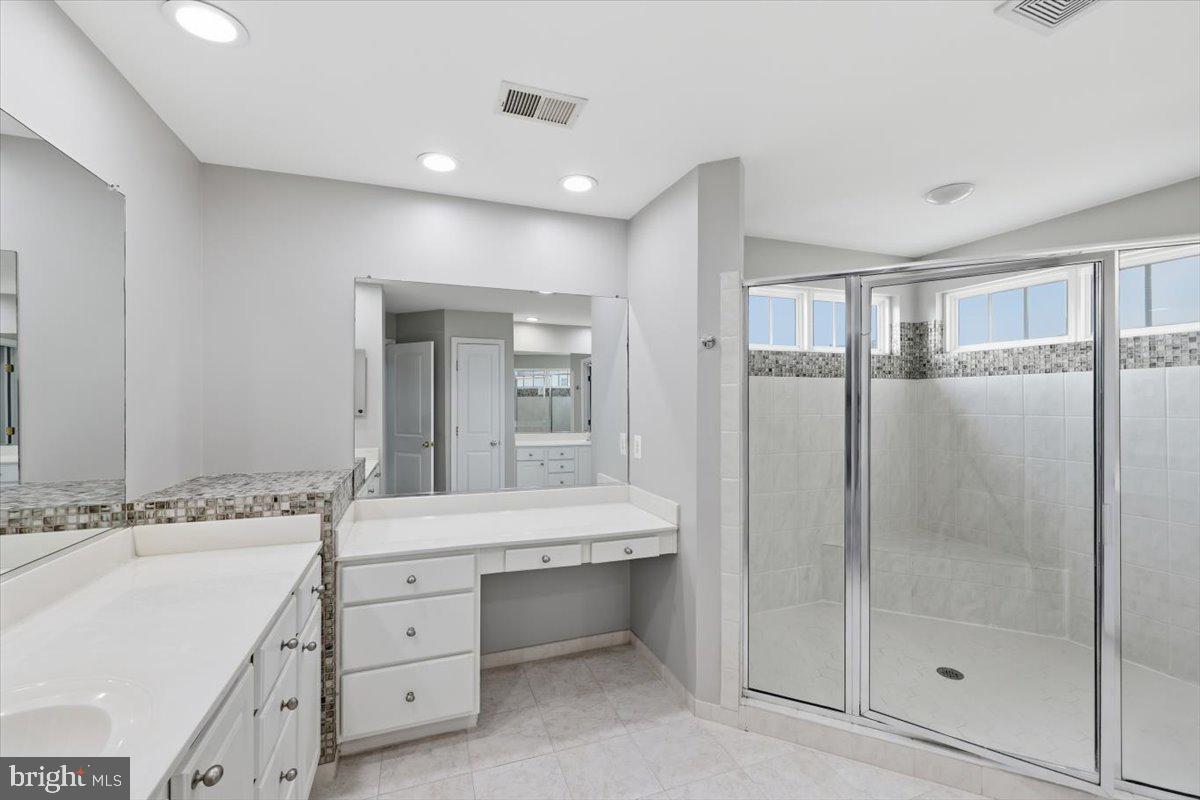 23706 Grapevine Ridge Terrace Clarksburg, MD 20871 - Photo 22 of 39 a bathroom with a double vanity sink mirror and shower