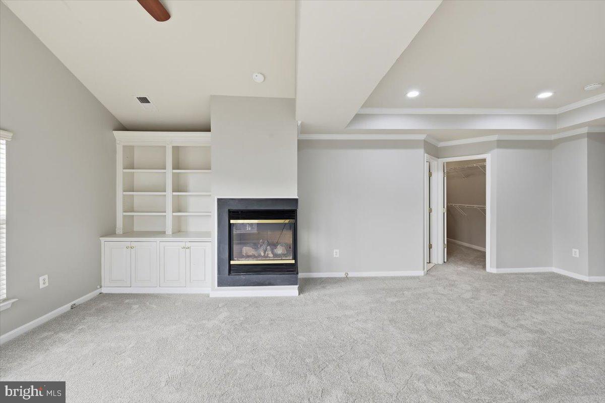 23706 Grapevine Ridge Terrace Clarksburg, MD 20871 - Photo 24 of 39 wooden floor hall with a fireplace and a cabinet