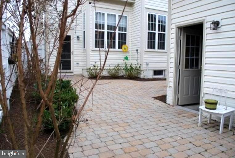 23706 Grapevine Ridge Terrace Clarksburg, MD 20871 - Photo 37 of 39 a view of a chair and table in backyard of the house