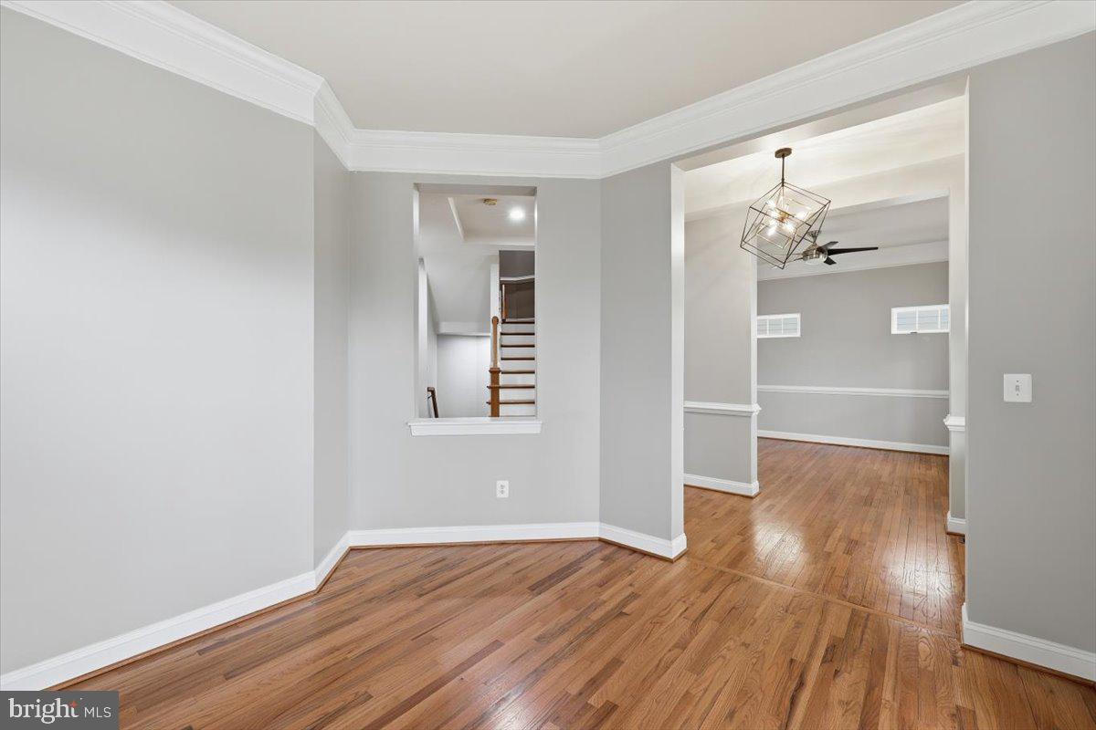 23706 Grapevine Ridge Terrace Clarksburg, MD 20871 - Photo 6 of 39 an empty room with wooden floor and windows