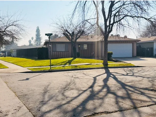 a view of a backyard with swimming pool