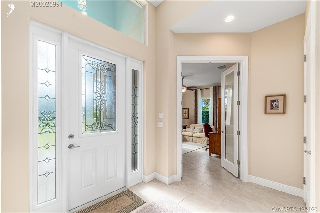 4981 Southeast Inlet Isle Way Stuart, FL 34997 - Photo 14 of 42 a view of a hallway with wooden floor and windows